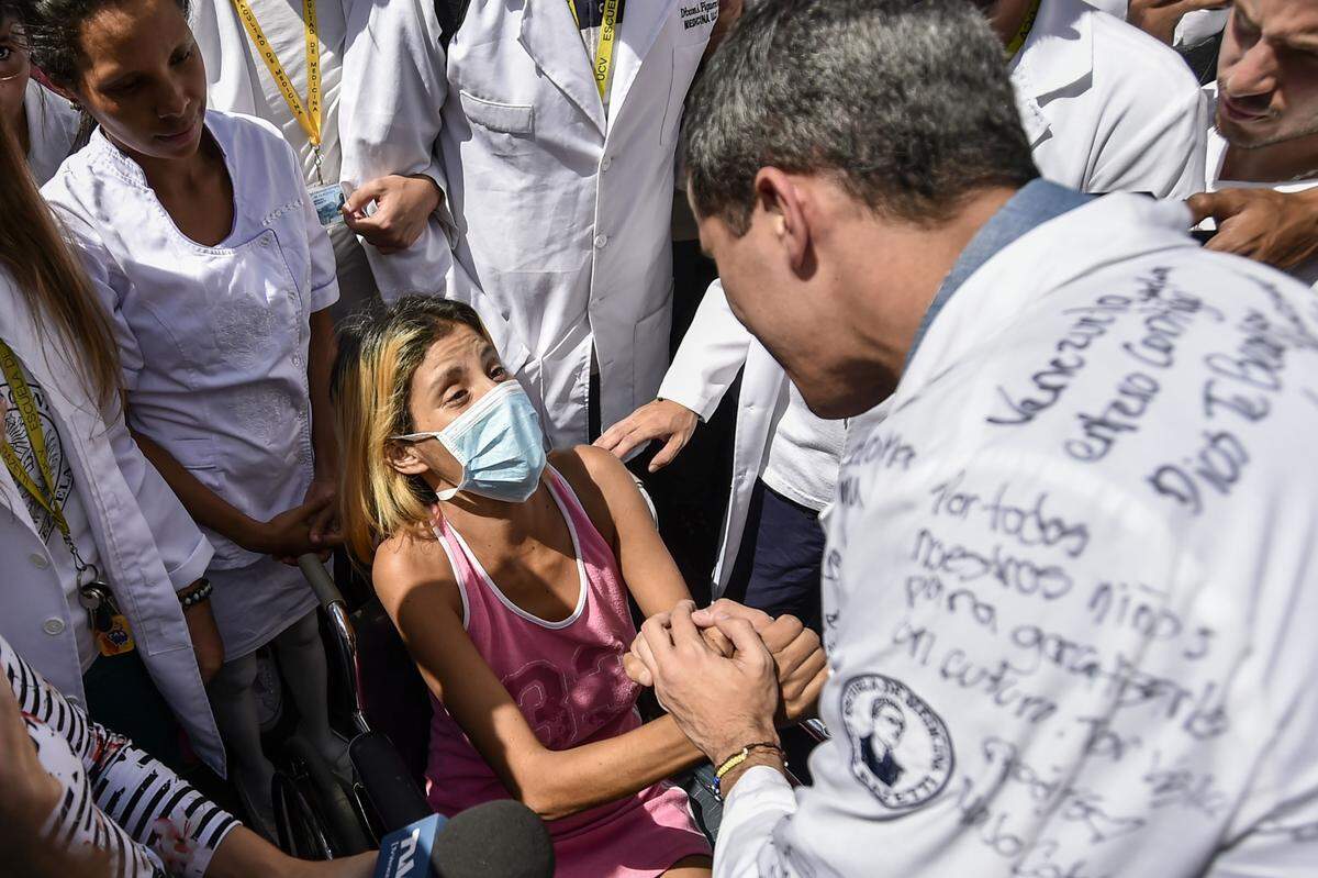El presidente interino Juan Guaidó conversa con una paciente en las afueras del Hospital Universitario de Caracas en medio de las protestas del 30 de enero del 2019.