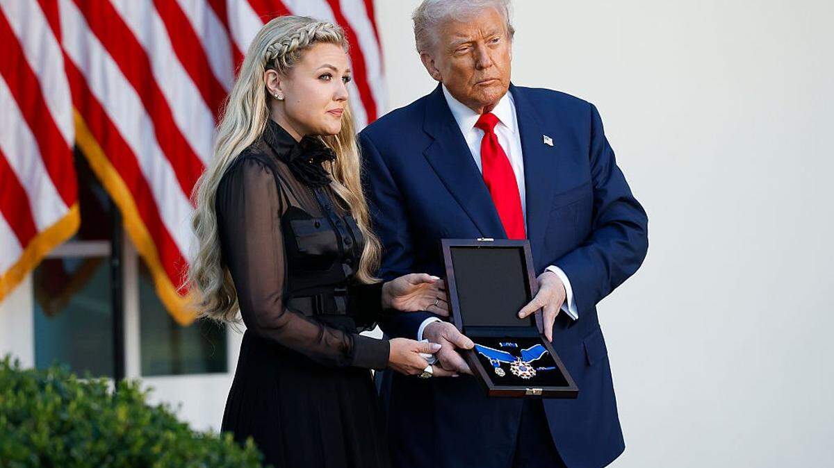 WASHINGTON, DC - OCTOBER 14: U.S. President Donald Trump posthumously awards the Presidential Medal of Freedom to late conservative activist Charlie Kirk as he presents the Medal to his wife Erika Kirk (L) during a ceremony in the Rose Garden of the White House on October 14, 2025 in Washington, DC. Today marks the National Day of Remembrance for Charlie Kirk who was shot and killed on September 10th at Utah Valley University. (Photo by Kevin Dietsch/Getty Images)