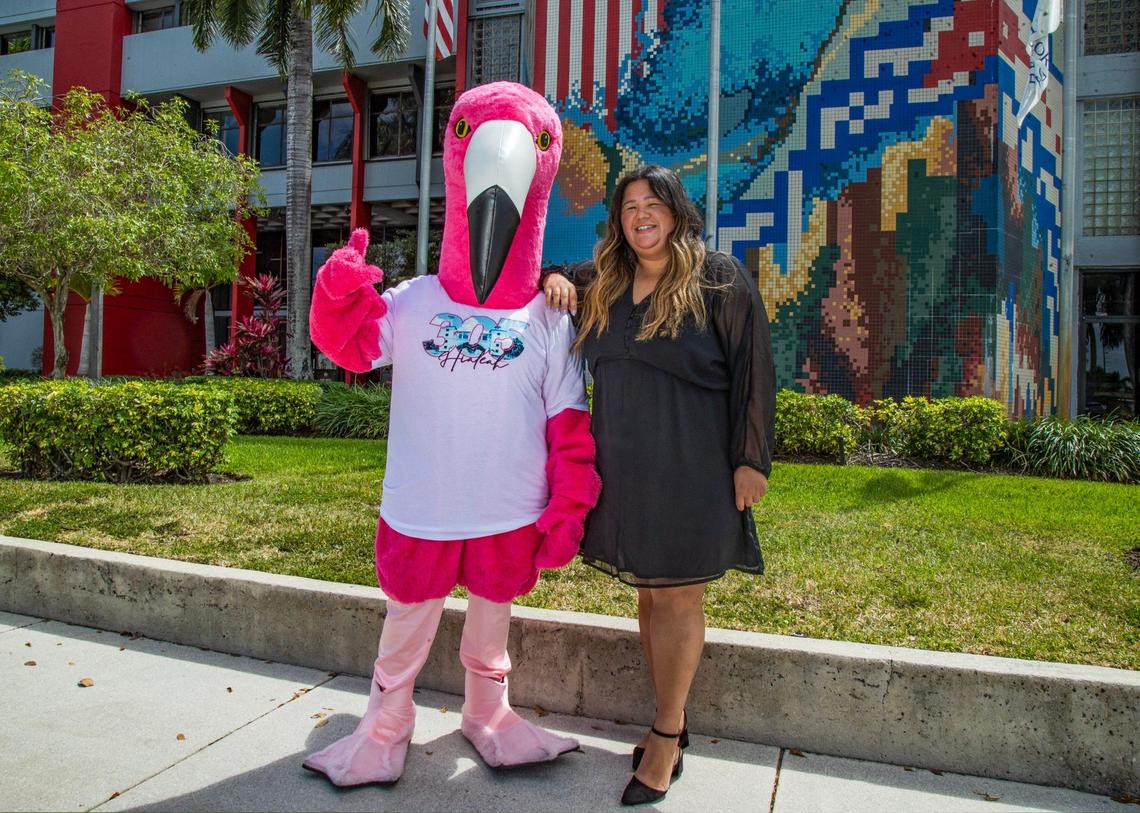 Hialeah Communications Director Alice Arrieta poses with Leah, the Hialeah Flamingo, the city’s official mascot, in front of City Hall on Tuesday, April 17, 2024.