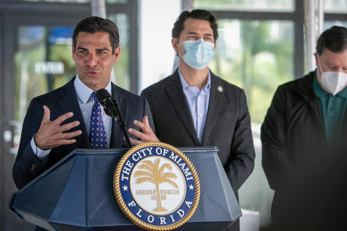 Miami Mayor Francis Suarez answers question from reporters during a press conference in front of Miami City Hall on Feb. 16, 2021. Next to the mayor are Commissioners Ken Russell (center) and Joe Carollo (right).