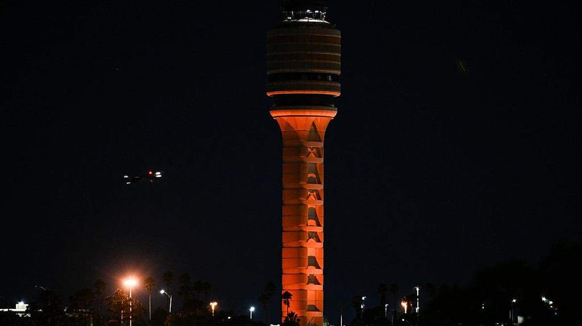 The air traffic control tower is seen at Orlando International Airport in Orlando, Florida early morning on October 31, 2025. Flights at Orlando International Airport faced major delays on October 30, after the Federal Aviation Administration (FAA) said the airport had no certified air-traffic controllers in its tower, forcing arrivals to be halted or severely delayed amid the ongoing US government shutdown. Air traffic controllers -- seen as "essential" public servants -- are kept at work during government shutdowns, but higher numbers are calling in sick rather than toiling without pay, leading to shortages. (Photo by Miguel J. Rodriguez Carrillo / AFP) (Photo by MIGUEL J. RODRIGUEZ CARRILLO/AFP via Getty Images)