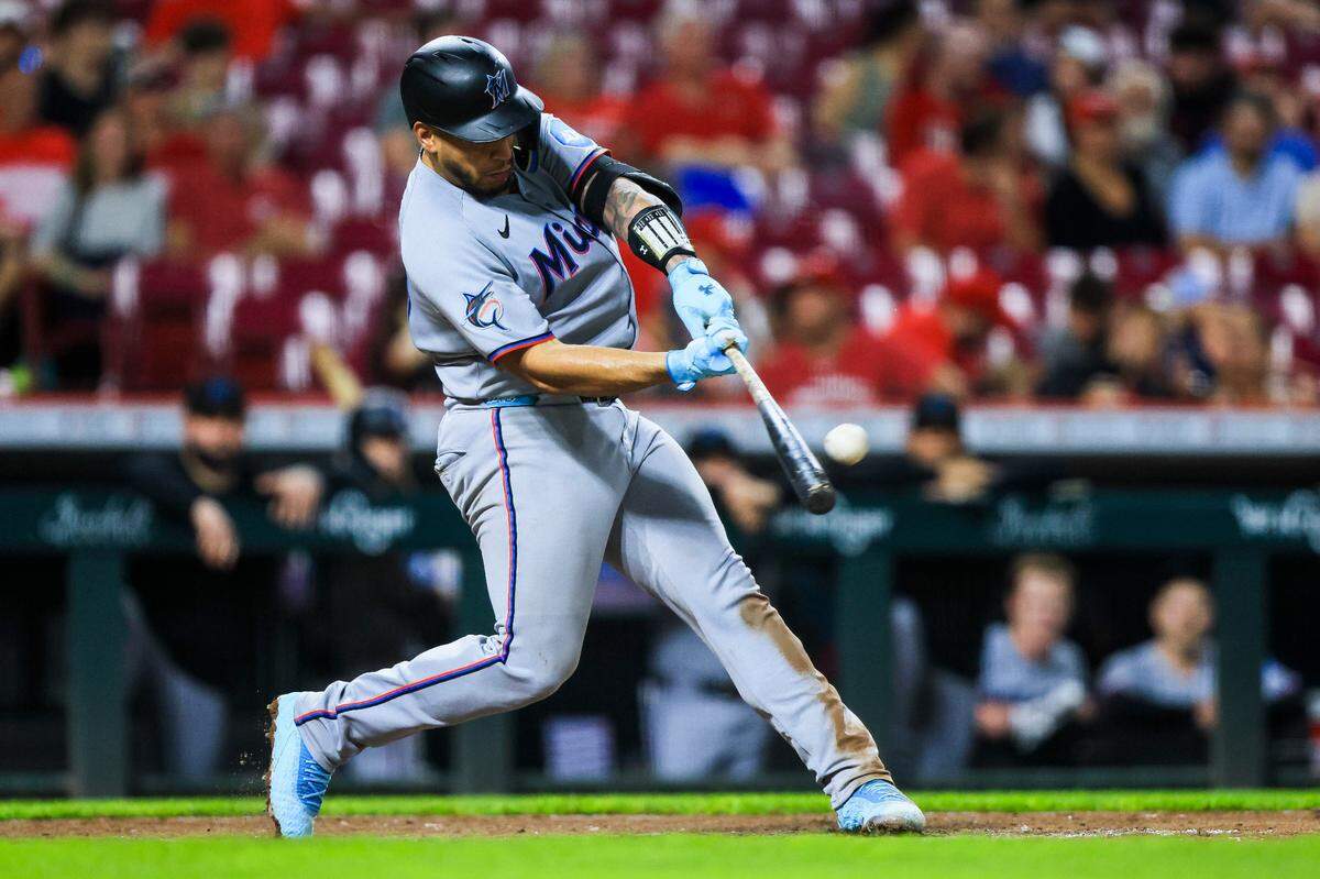 Jul 7, 2025; Cincinnati, Ohio, USA; Miami Marlins catcher Agustin Ramirez (50) hits a solo home run in the seventh inning against the Cincinnati Reds at Great American Ball Park. Mandatory Credit: Katie Stratman-Imagn Images