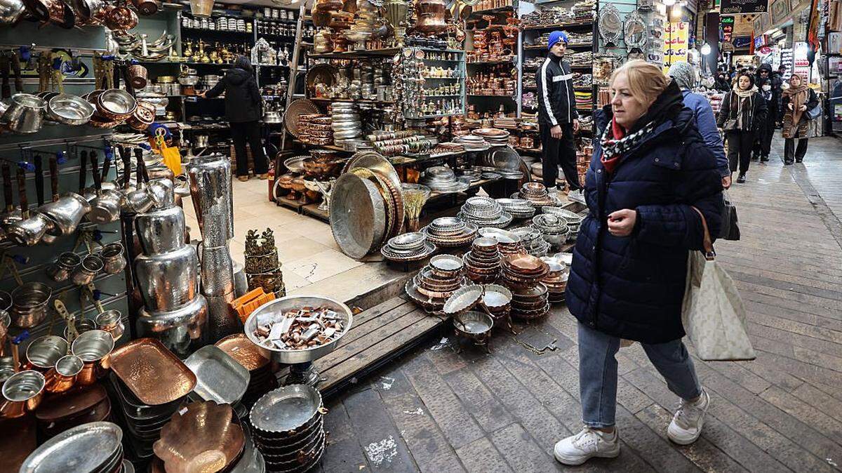 People shop at Tajrish Bazaar in the Iranian capital Tehran on December 29, 2025. (Photo by ATTA KENARE / AFP via Getty Images)