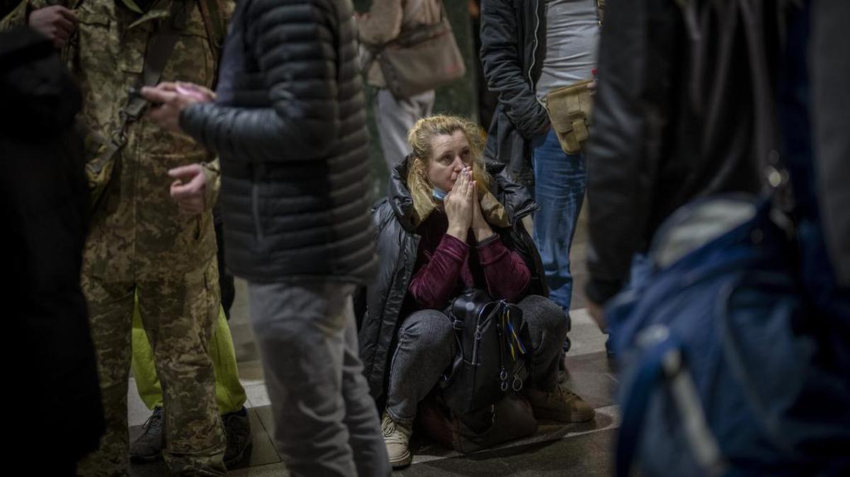 Una mujer reacciona mientras espera un tren que intenta salir de Kiev, Ucrania, el jueves 24 de febrero de 2022.  (Foto AP/Emilio Morenatti)