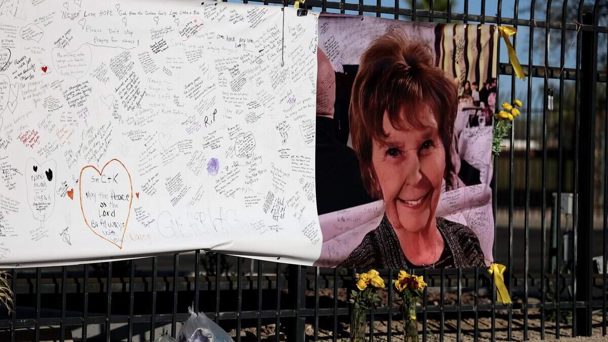 TUCSON, ARIZONA - FEBRUARY 26: A photograph of Nancy Guthrie is seen on a sign that people can leave messages on February 26, 2026, in Tucson, Arizona. Law enforcement officials continue to search for Nancy Guthrie, the 84-year-old mother of U.S. journalist and television host Savannah Guthrie, after she went missing from her home on the morning of February 1st. (Photo by Joe Raedle/Getty Images)