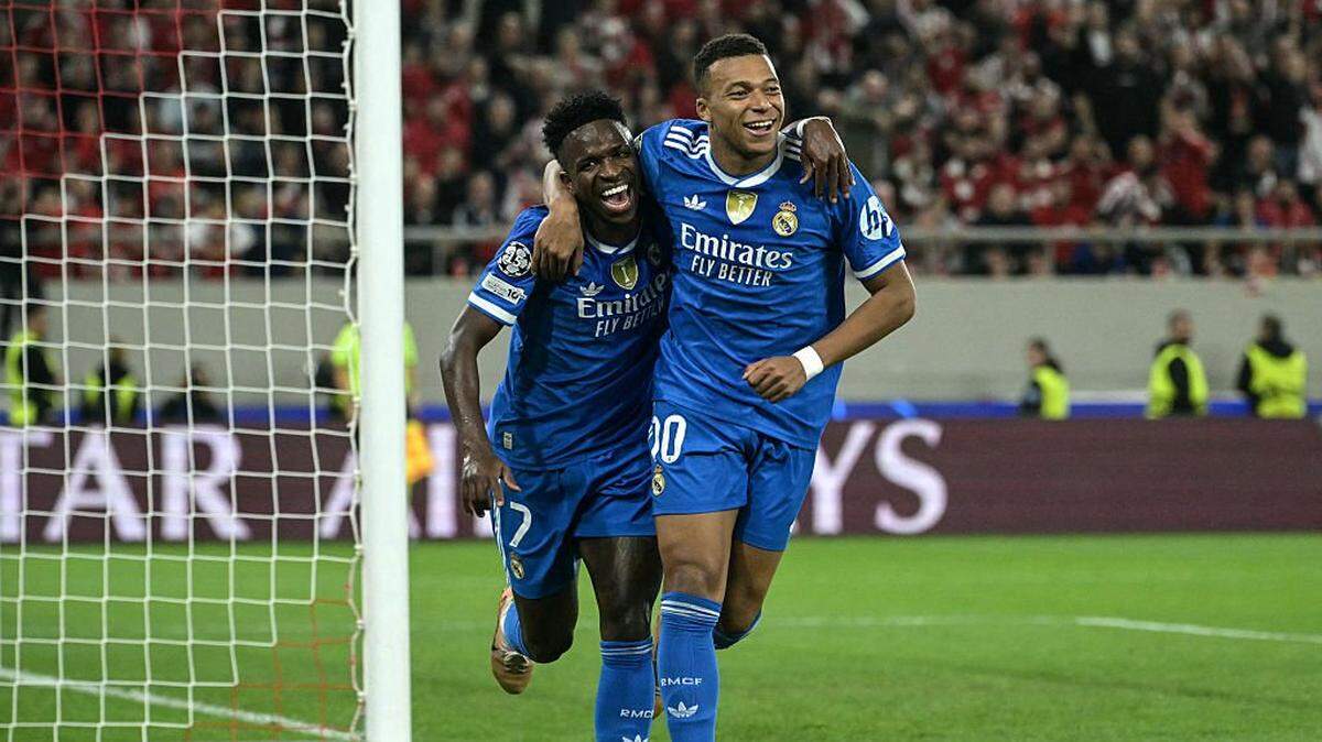 El astro del Real Madrid Kylian Mbappé (der.) celebra con el brasileño Vinicius Junior tras anotar un gol ante Olympiakos, en el partido de la Liga de Campeones efectuado el 26 de noviembre de 2025 en Piraeus, Grecia.
