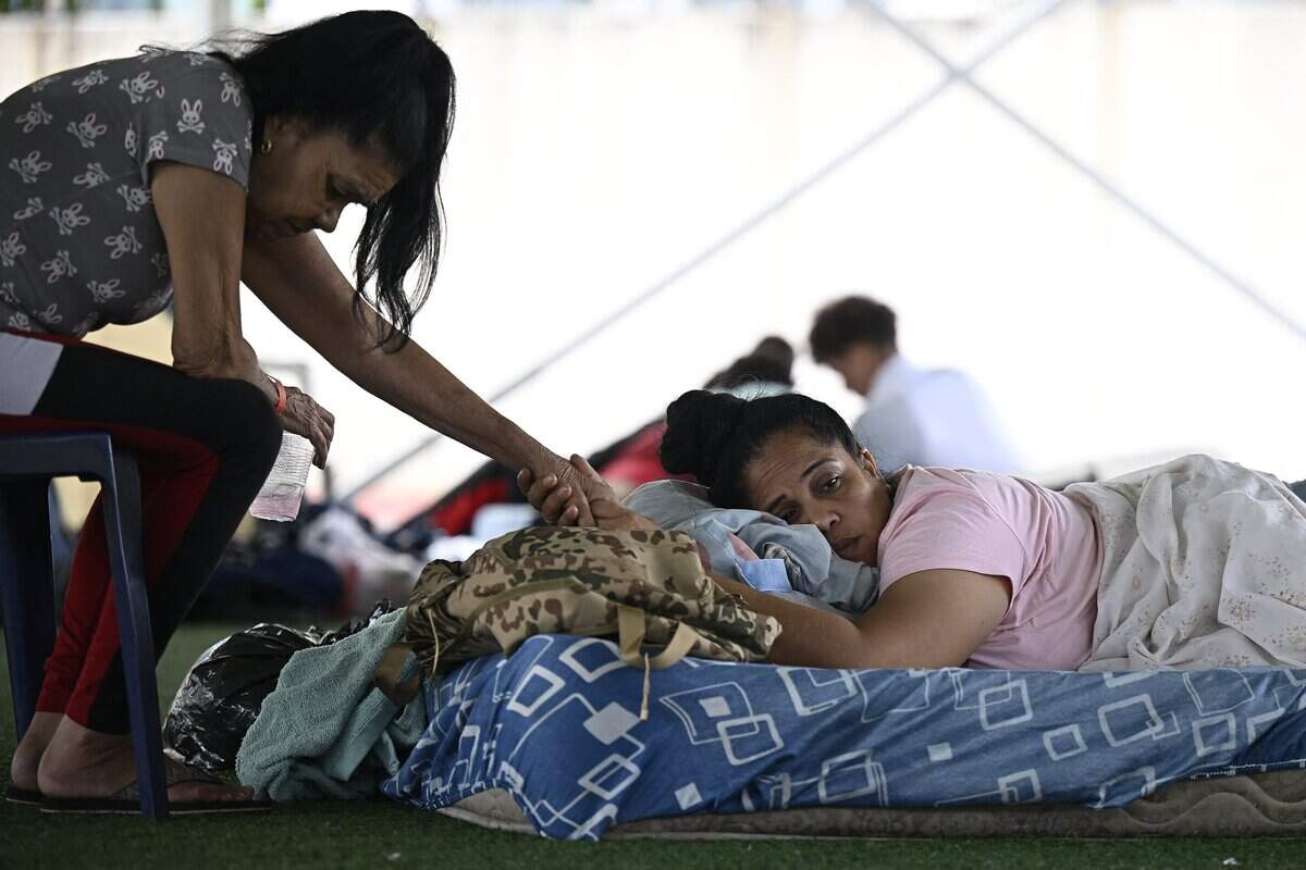 TOPSHOT - Locals displaced following the June 24 twin earthquakes take a rest in an improvised camp at the Jose Maria Vargas sports complex in Maiquetia, La Guaira state, Venezuela, on June 30, 2026. Tens of thousands of people urgently need food and shelter in Venezuela due to the devastation from two huge earthquakes that killed more than 1,700 and injured 5,000, the UN said on June 30, 2026, as doctors warned of potential outbreaks of disease. (Photo by Federico PARRA / AFP via Getty Images)