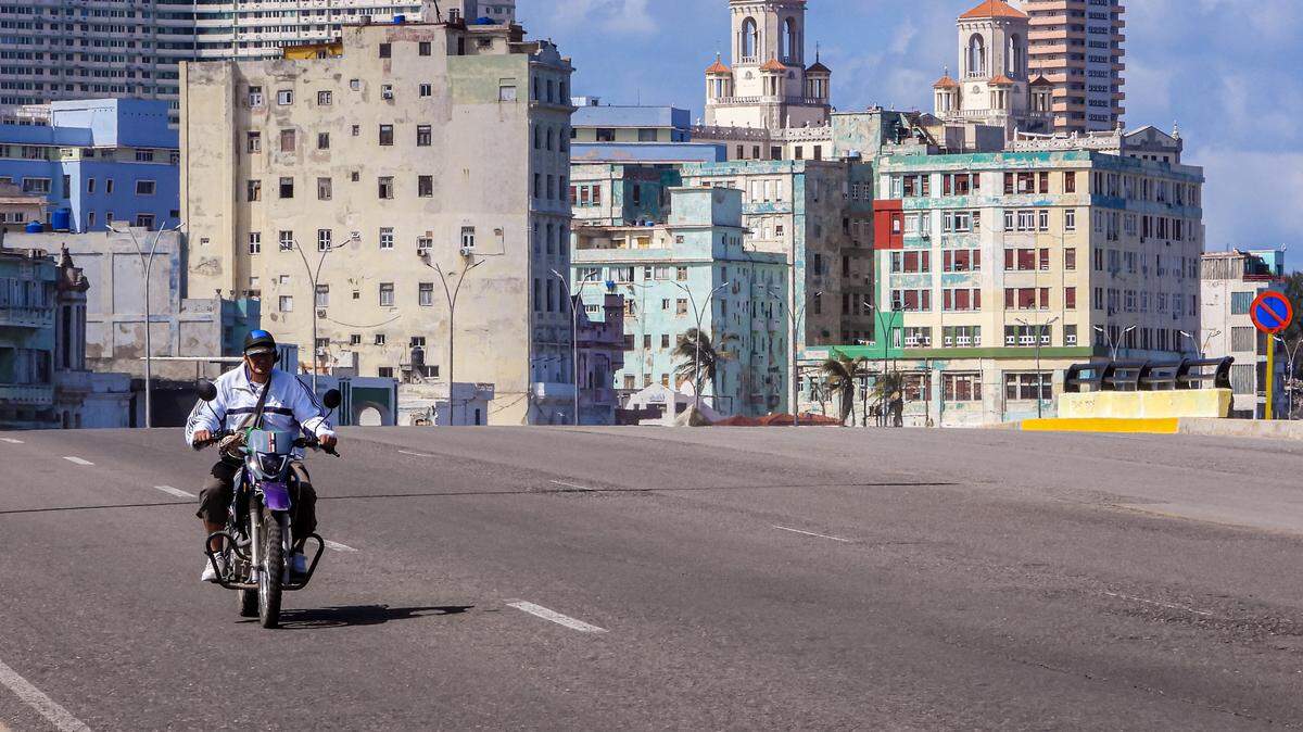 A man rides along an empty road in Havana on February 8, 2026. The Cuban government on February 6 announced emergency measures to address a crippling energy crisis worsened by US sanctions, including the adoption of a four-day work week for state-owned companies and fuel sale restrictions. (Photo by ADALBERTO ROQUE / AFP via Getty Images)
