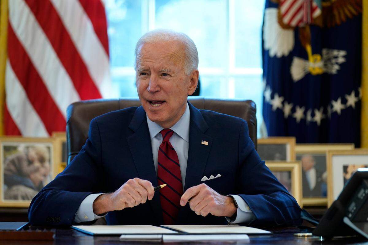 President Joe Biden signs a series of executive orders on health care, in the Oval Office of the White House, Thursday, Jan. 28, 2021, in Washington. The Democratic push to raise the minimum wage to $15 an hour has emerged as an early flash point in the push for a $1.9 trillion COVID relief package, providing an early test of President Joe Biden’s ability to bridge Washington’s partisan divide in pursuing his first major legislative victory. (AP Photo/Evan Vucci)