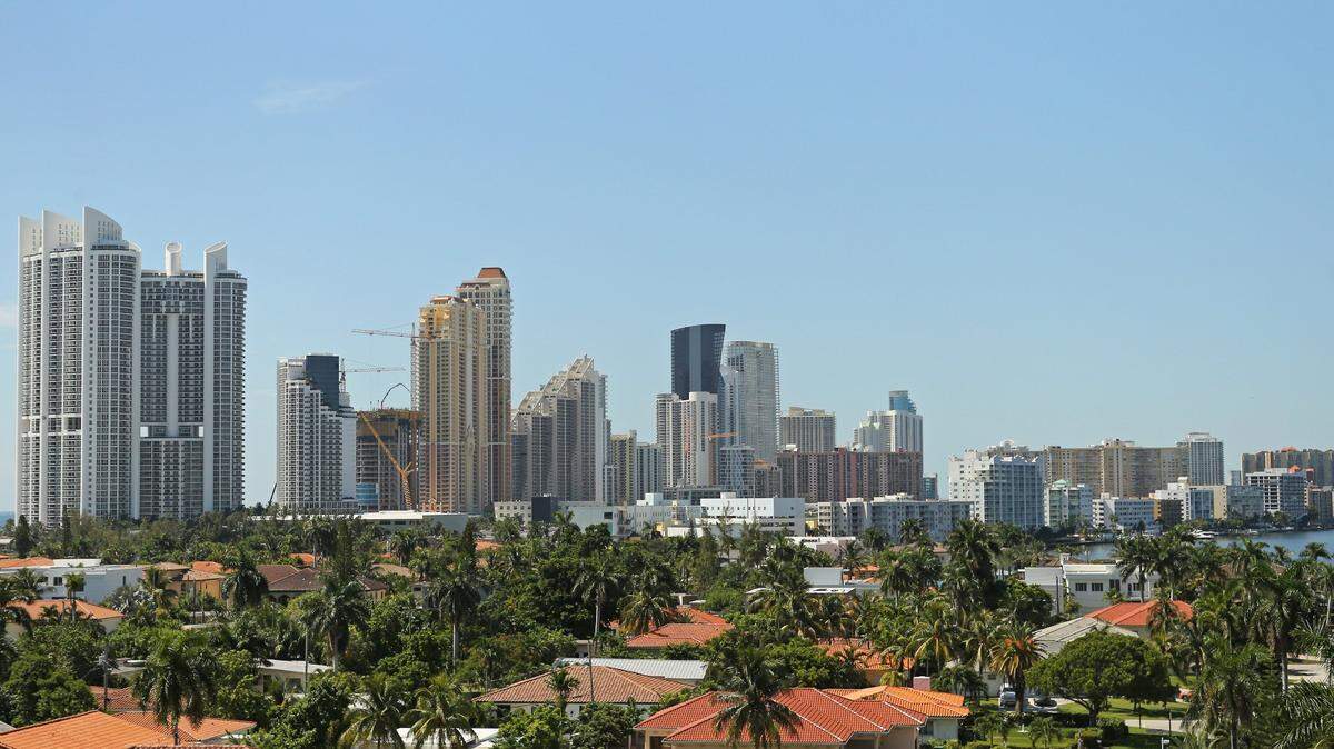 An aerial view of single-family homes and, in the distance, waterfront condos in Sunny Isles Beach.