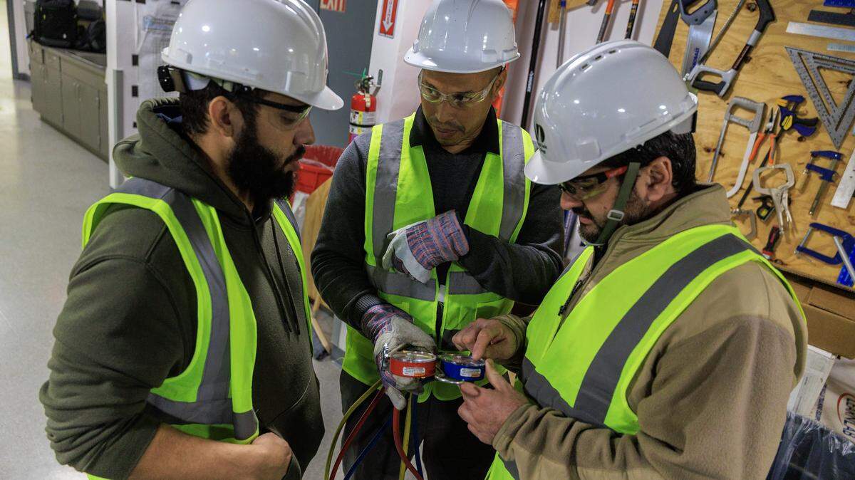 From left- Students Juan Gonzalez, Reinier Colas and Francisco Jimenez, practiced using an AC pressure gauge, during an HVAC/R Technician Certificate Program class, at Miami Dade College North Campus, in North Miami, on Thursday, February 05, 2026.
