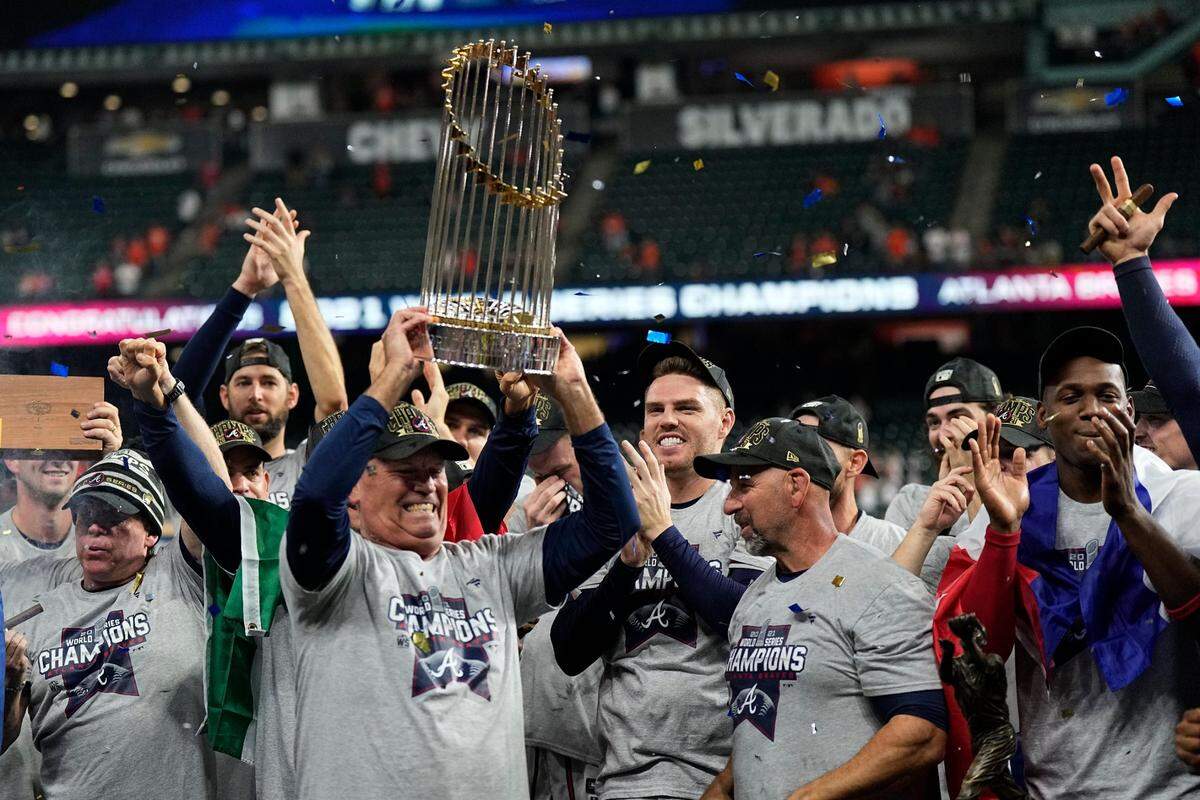 Atlanta Braves manager Brian Snitker lifts the World Series trophy last November in this AP file photo. The Braves are bringing the trophy to Macon in March.