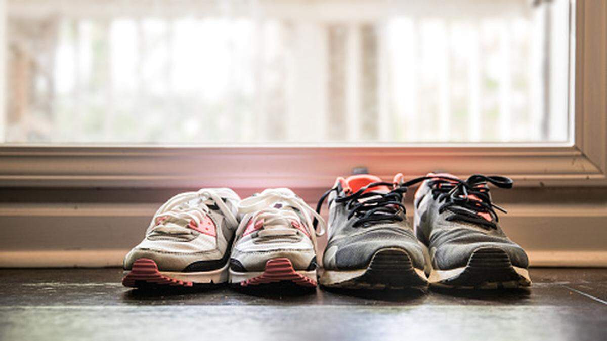 Still life of different size shoes on floor at home