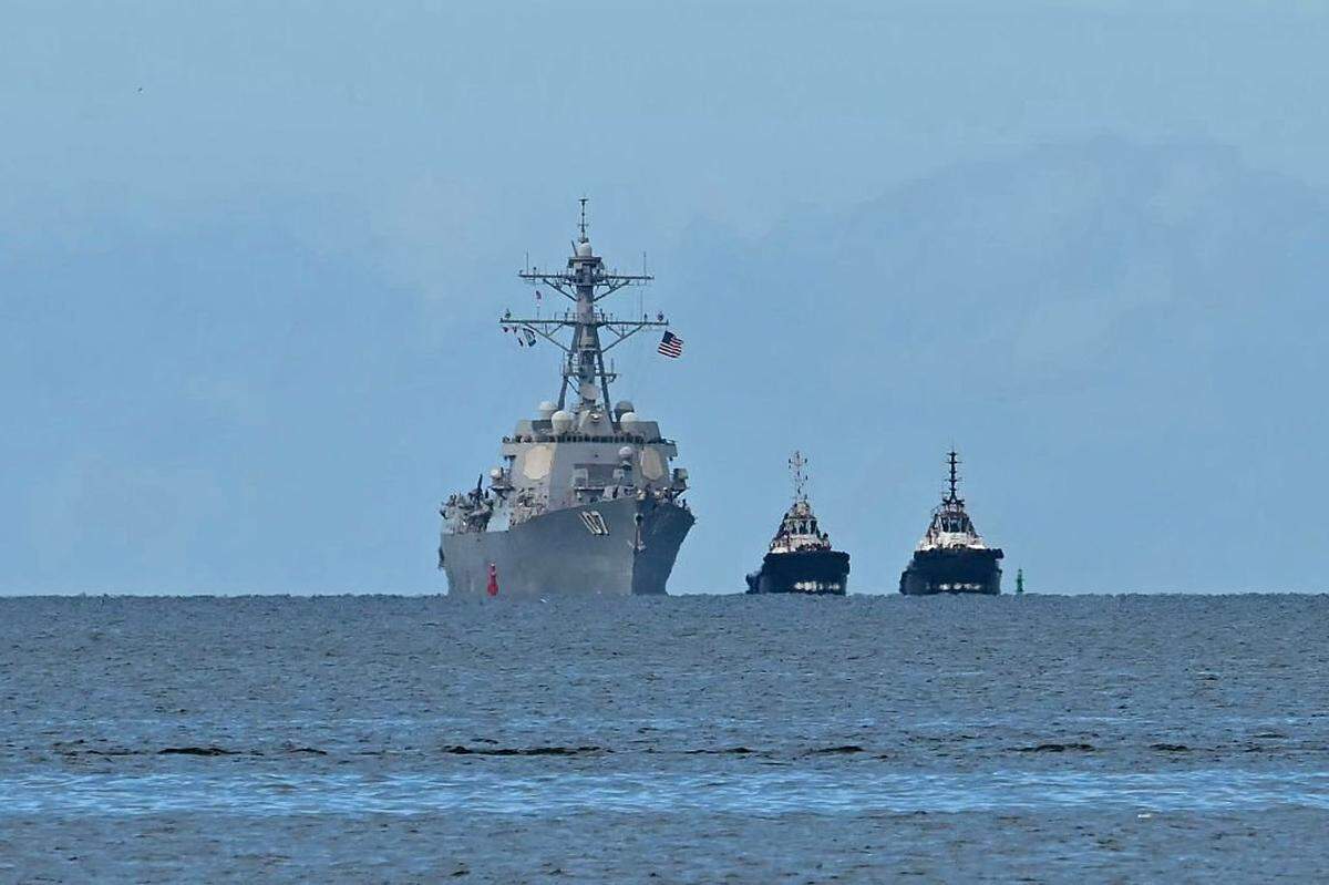 The USS Gravely warship is seen at a distance off the coast of Port of Spain on October 26, 2025. The US warship will visit Trinidad and Tobago for joint exercises near the coast of Venezuela amid Washington's campaign against alleged drug traffickers in the region. (Photo by Martin BERNETTI / AFP) (Photo by MARTIN BERNETTI/AFP via Getty Images)