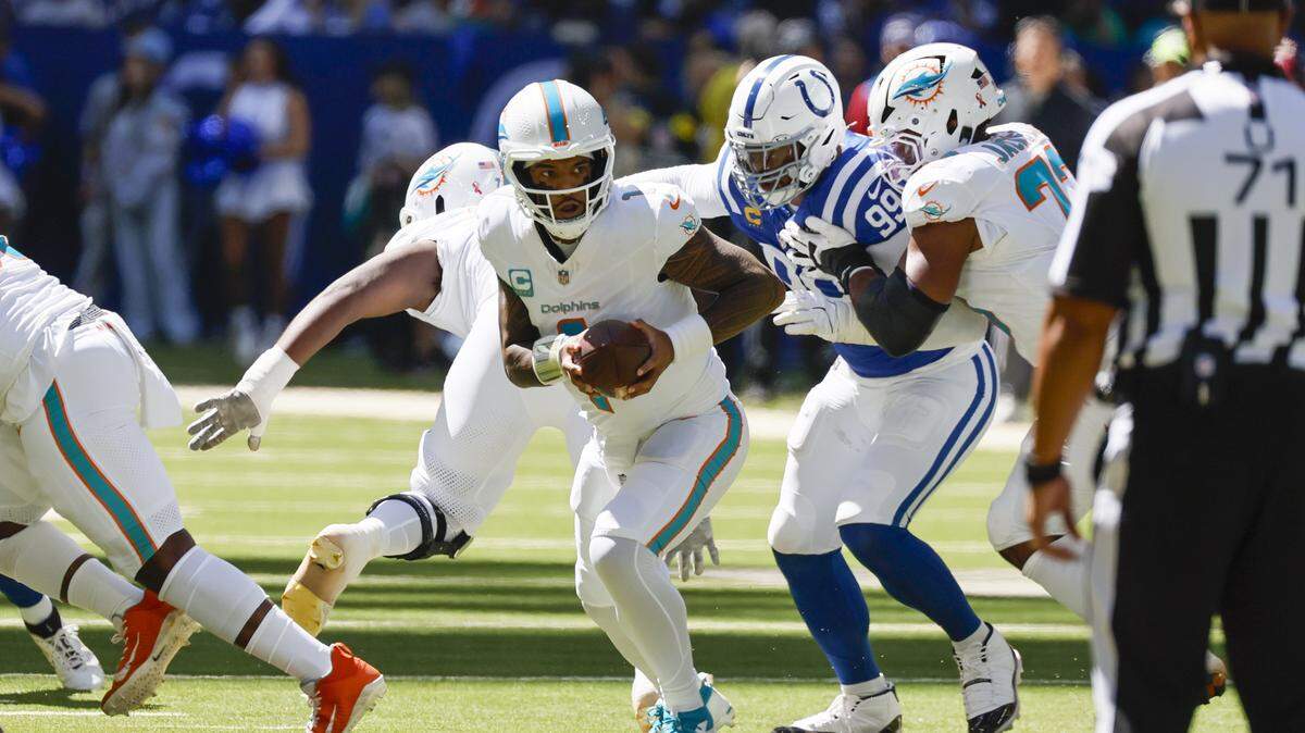 El quarterback de los Dolphins, Tua Tagovailoa (1), trata de escapar del linebacker de los Colts, Keion White, en el juego celebrado el 7 de septiembre de 2025 en Indianápolis, Indiana.