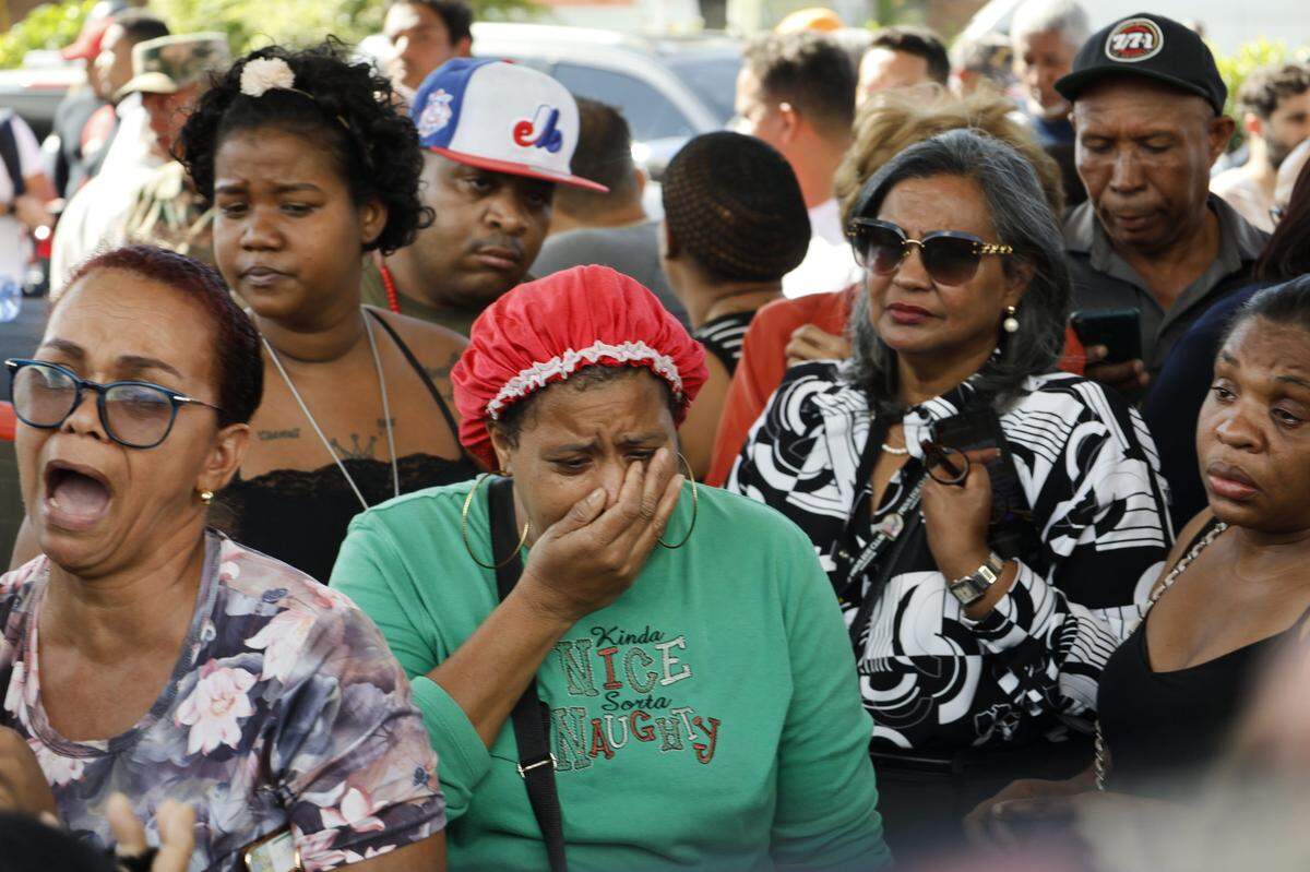Relatives and friends of the victims wait for information near a nightclub where the roof collapsed, in Santo Domingo, Dominican Republic, Tuesday, April 8, 2025.