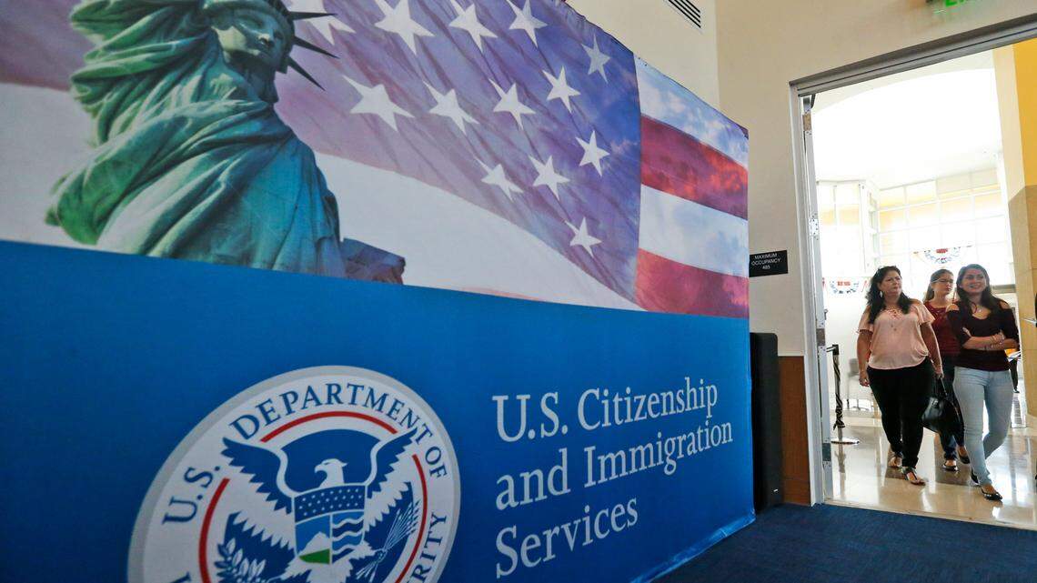 People arrive before the start of a naturalization ceremony at the U.S. Citizenship and Immigration Services Miami Field Office, Friday, Aug. 17, 2018, in Miami. One hundred forty-two citizenship candidates from 33 countries took the Oath of Allegiance. (AP Photo/Wilfredo Lee)