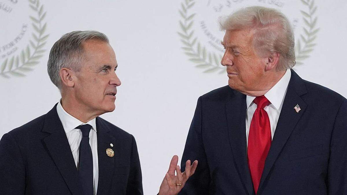 US President Donald Trump greets Canada's Prime Minister Mark Carney during a summit on Gaza in Sharm el-Sheikh on October 13, 2025. Trump landed in Egypt on October 13 for a summit on Gaza, following a lightning visit to Israel after a ceasefire he brokered entered into force. (Photo by Evan Vucci / POOL / AFP) (Photo by EVAN VUCCI/POOL/AFP via Getty Images)
