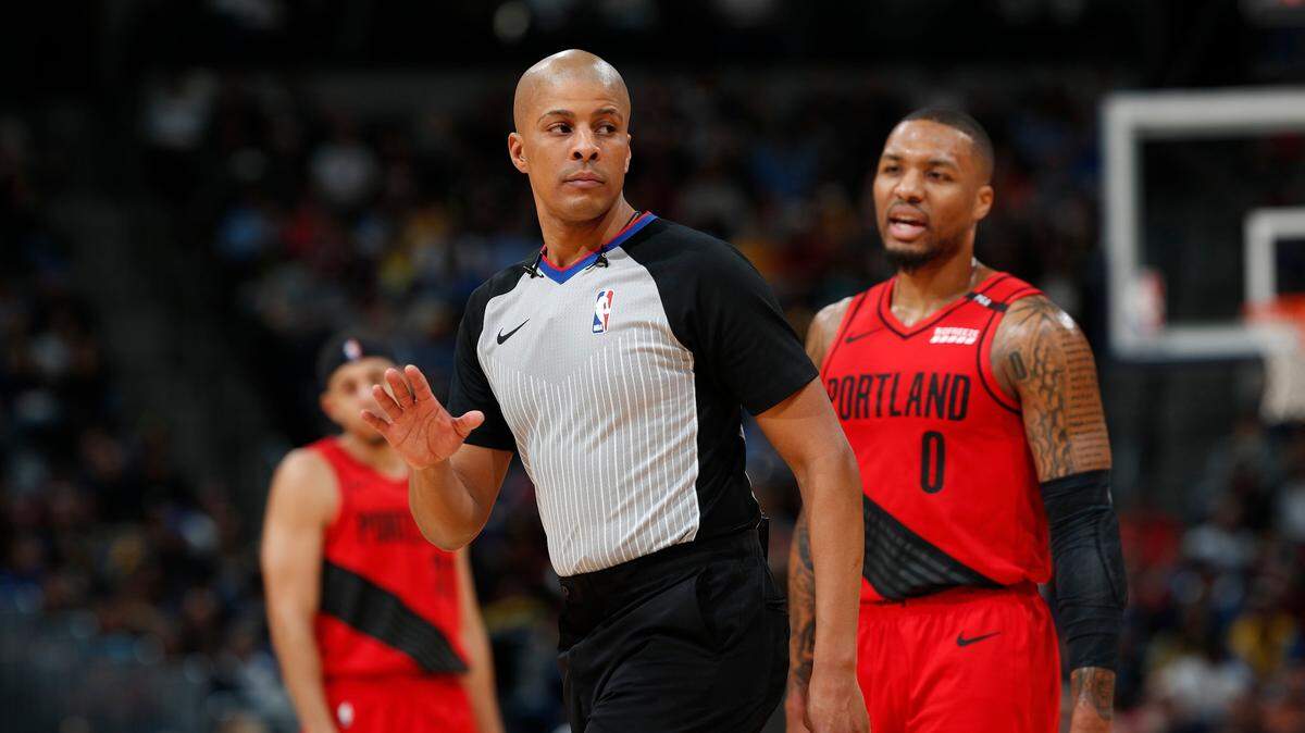 Referee CJ Washington, front, walks away fro Portland Trail Blazers guard Damian Lillard (0) in the first half of an NBA basketball game Sunday, Jan. 13, 2019, in Denver. (AP Photo/David Zalubowski)