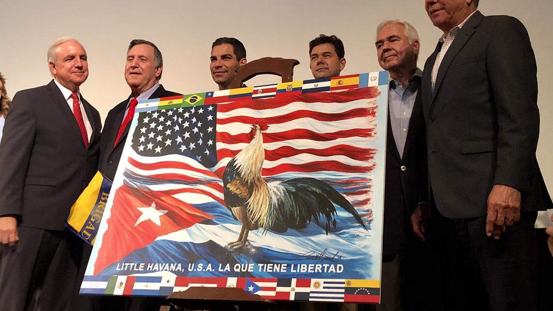 The mayor of Miami, Carlos A. Giménez, presents the new flag of Little Havana.