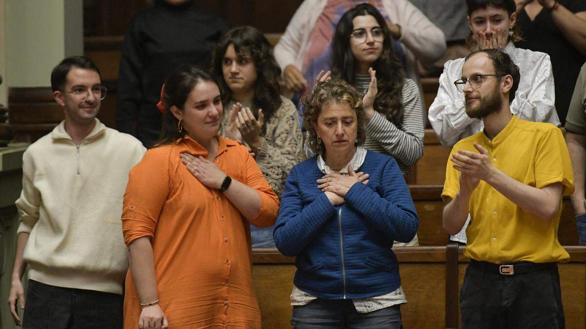 Florencia Salgueiro (L), a leading advocate for assisted dying in Uruguay, and her mother Rosana Rubio (C) celebrate the approval of the euthanasia law at the Legislative Palace in Montevideo on October 15, 2025. Uruguay passed on October 15, 2025, a law authorizing euthanasia under certain conditions, after a thoughtful and lengthy debate in the Senate. (Photo by Santiago Mazzarovich / AFP) (Photo by SANTIAGO MAZZAROVICH/AFP via Getty Images)