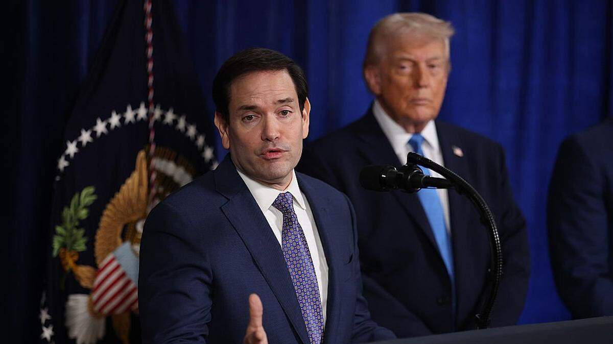 PALM BEACH, FLORIDA - JANUARY 03: U.S. Secretary of State Marco Rubio speaks during a press conference as U.S. President Donald Trump listens at Mar-a-Lago club on January 03, 2026, in Palm Beach, Florida. During the event, President Trump confirmed that the U.S. military carried out a large-scale strike in Caracas overnight, resulting in the capture of Venezuelan leader Nicolas Maduro and his wife, Cilia Flores. (Photo by Joe Raedle/Getty Images)