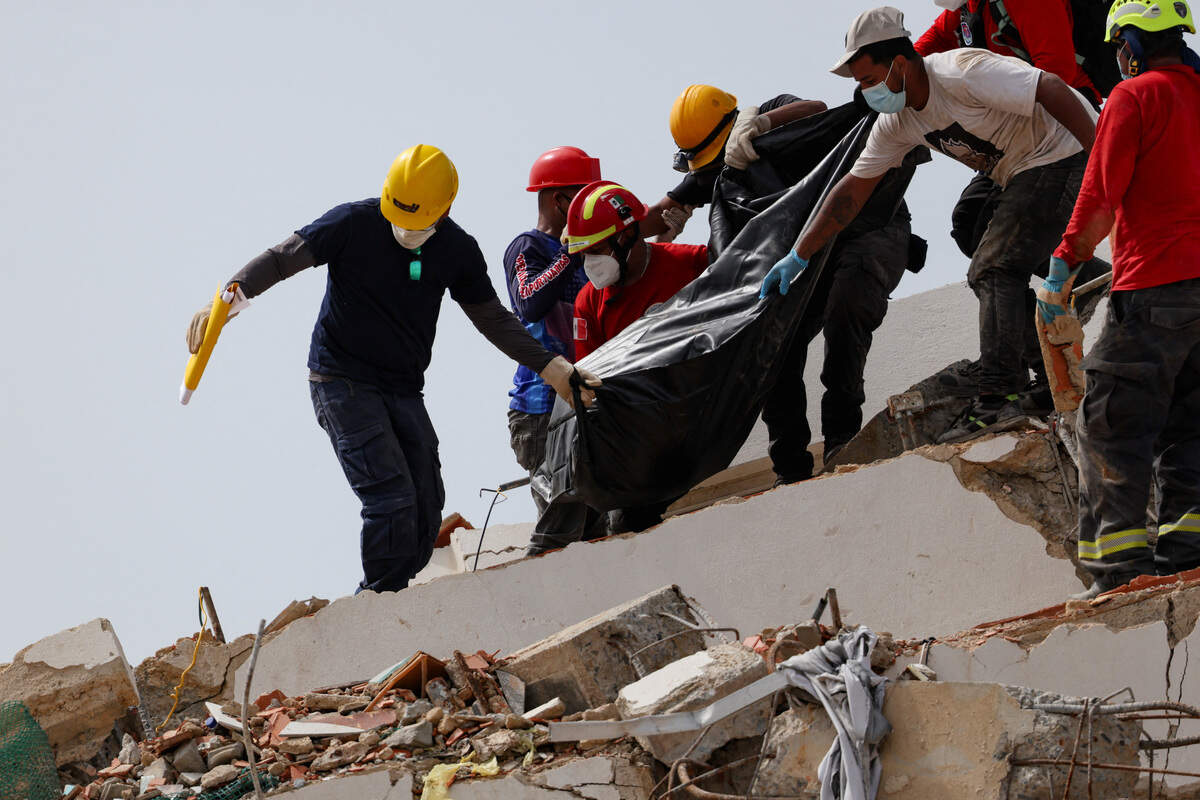 Rescue teams recover the body of a victim at the site where a building collapsed following the June 24 earthquakes in Los Corales, La Guaira, on July 4, 2026.