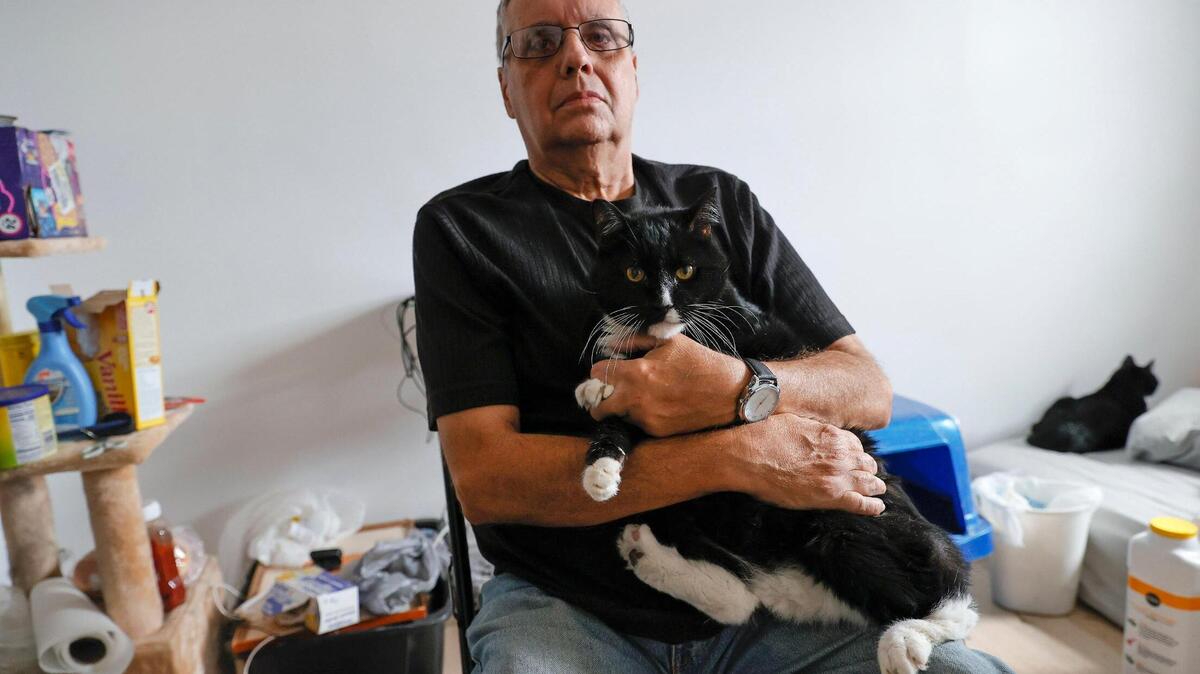 Writer Ismael Lorenzo, 76, with Felipito his 15 years cat in his rented room located 4179 East 8th Court in Hialeah, Fl. on Wednesday, February 16, 2022. Lorenzo was evicted, by court order, from the apartment he rented in North Miami. When his contract began in September, he was not informed that the house was in foreclosure, and they kept the deposit money. He now has only been able to find a room in Hialeah for $1,100.