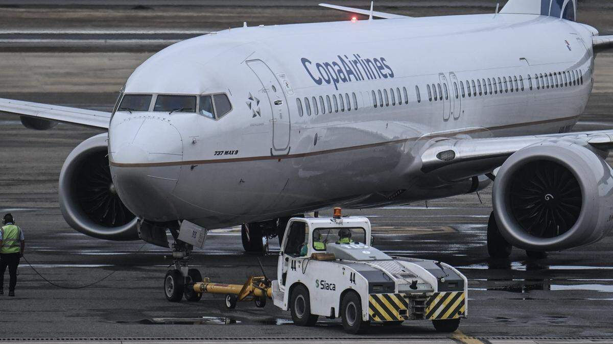 A Copa Airlines plane is pictured on the tarmac at Simon Bolivar International Airport in Maiquetia, Venezuela on November 24, 2025. Six airlines cancelled flights to Venezuela on November 22, 2025, an industry group said, after the US aviation regulator warned of dangers from "heightened military activity" amid a major buildup of American forces in the region. (Photo by Juan BARRETO / AFP via Getty Images)