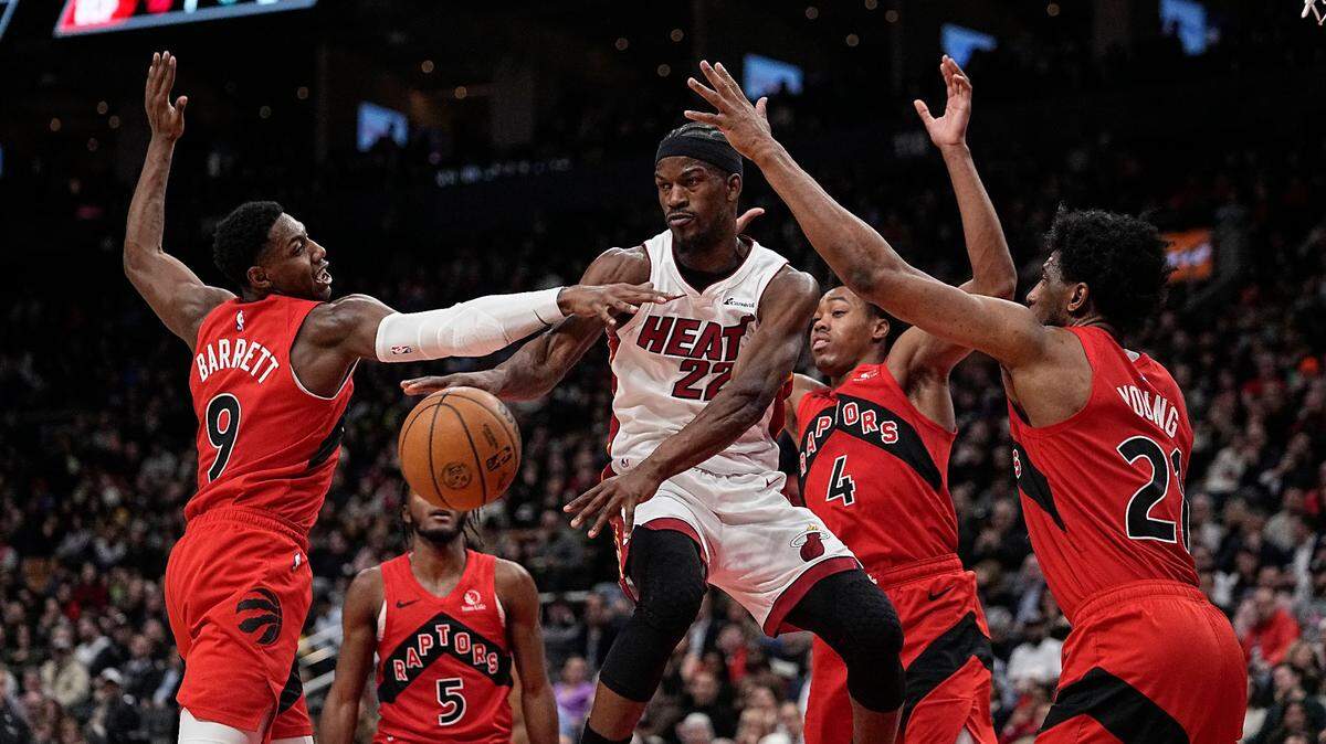 El jugador del Heat de Miami Jimmy Butler (22) trata de pasar la pelota ante la defensa de los Raptors, en el partido celebrado el 17 de enero de 2024 en Toronto.