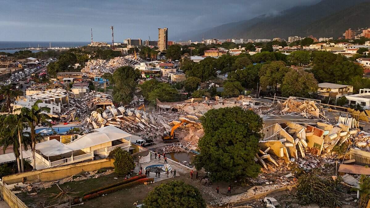 This aerial view shows buildings destroyed following twin earthquakes in Caraballeda, La Guaira State, Venezuela, on June 29, 2026. Hopes were fading of finding survivors more than four days after powerful twin earthquakes struck Venezuela, as residents grow increasingly frustrated with the government's response to the disaster that has killed -up to now- more than 1,700 people and left tens of thousands unaccounted for. (Photo by Miguel MEDINA / POOL / AFP via Getty Images)