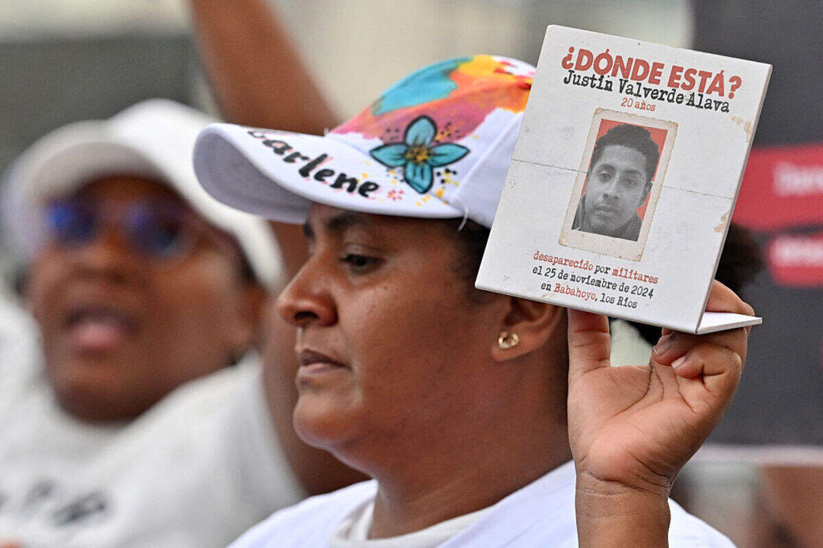 Una mujer muestra un cartel con el retrato de una víctima mientras participa en una protesta, durante un acto de disculpa pública del gobierno ecuatoriano por la desaparición forzada de los cuatro niños de Las Malvinas, en el hemiciclo de la Rotonda de Guayaquil, Ecuador, el 4 de junio de 2026.