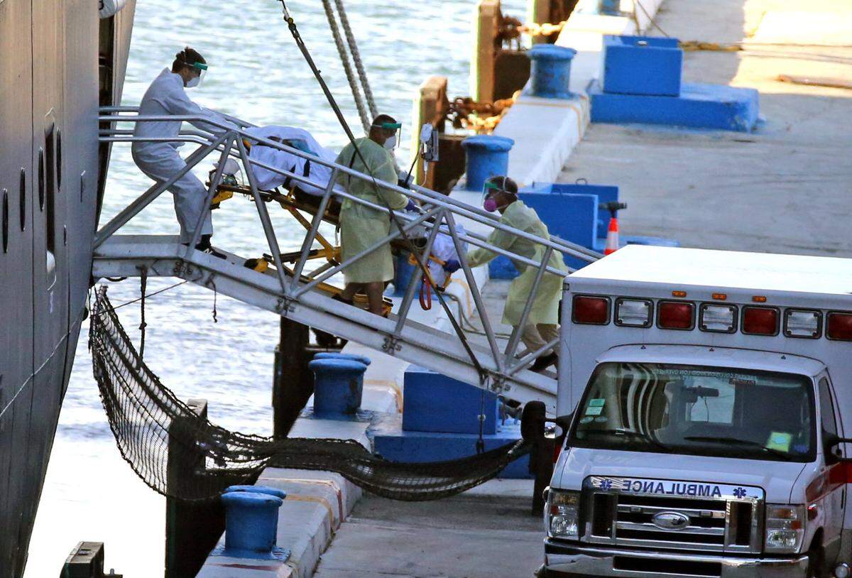 A patient is rolled off the Zaandam cruise ship. The ship has COVID-19 and has been at sea for 12 days before docking at Port Everglades in Fort Lauderdale, Florida, April 2, 2020.