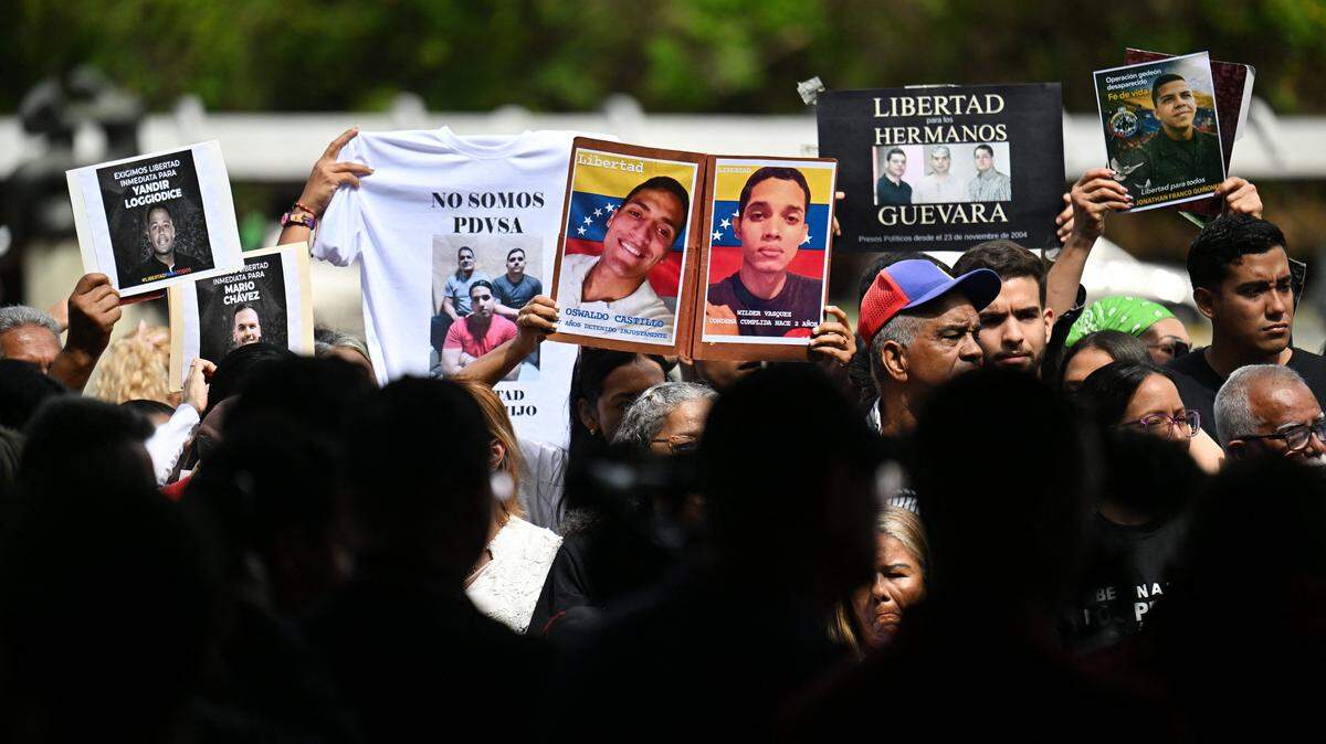 Relatives hold portraits of political prisoners during a demonstration by relatives at the Central University of Venezuela in Caracas on January 13, 2026. Venezuela said on January 12, it had freed dozens more political prisoners as rights groups questioned the numbers and family members clamored for speedier releases after the US military ouster of long-term autocrat Nicolas Maduro. (Photo by Juan BARRETO / AFP via Getty Images)