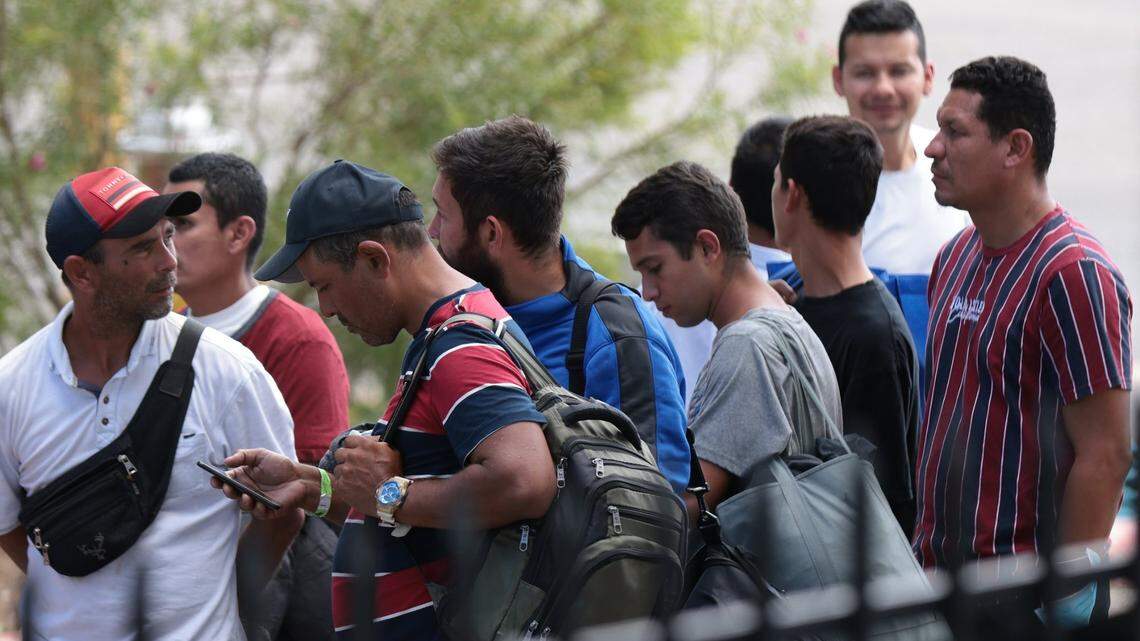 In 2022, migrants in San Antonio, Texas, line up for snacks at a resource center run by Catholic Charities.