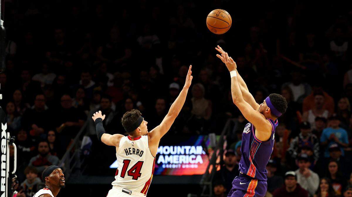 El jugador de los Suns Devin Booker tira al aro ante la marca de Tyler Herro, del Heat de Miami, en el partido celebrado el 5 de enero de 2024 en Phoenix.