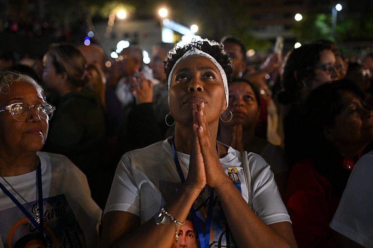 A catholic faithful prays during the canonization ceremony of Venezuelan doctor Jose Gregorio Hernandez and Venezuelan Sister Maria Rendiles at the Nuestra Senora de la Candelaria church in Caracas on October 19, 2025. (Photo by Federico PARRA / AFP) (Photo by FEDERICO PARRA/AFP via Getty Images)