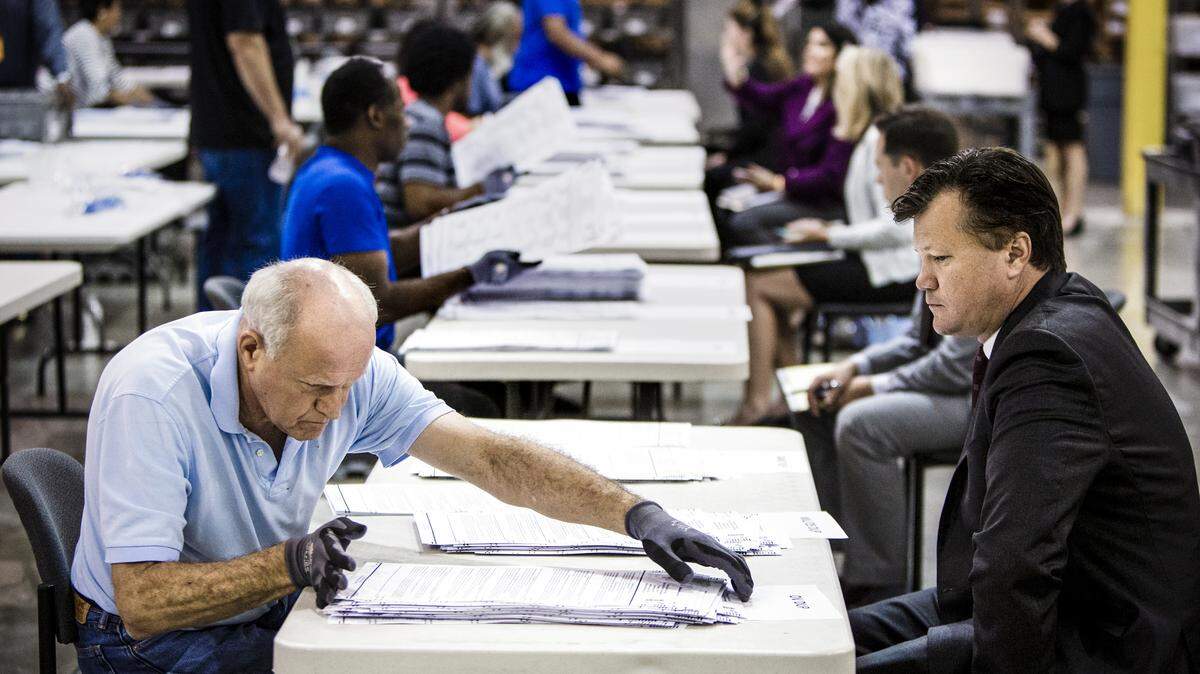 An elections observer oversees the recount process in Palm Beach County on Saturday.