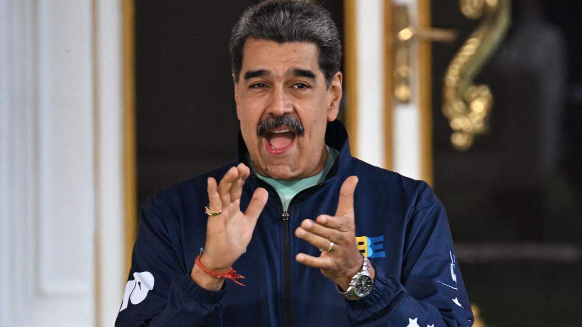 Venezuela's President Nicolas Maduro claps during the student day celebrations at Miraflores palace in Caracas, November 21, 2025. (Photo by Juan BARRETO / AFP via Getty Images)