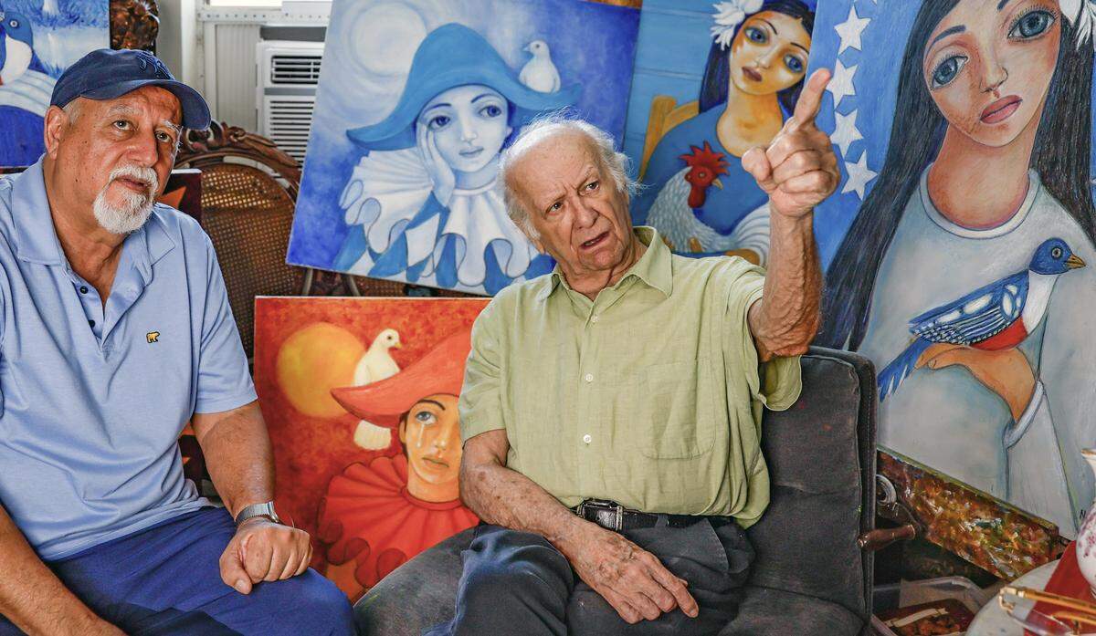 Cuban filmmaker Jorge Soliño speaks with self-taught painter Orlando González Naranjo, born in Cuba and based in Miami, while visiting Naranjo at his home studio on Friday, May 15, 2026, in Miami , Florida.
