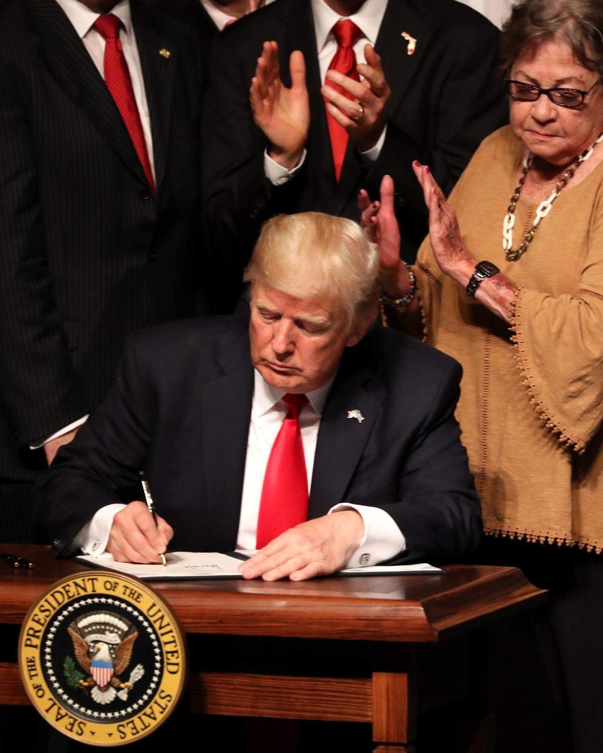 U.S. President Donald Trump signs Cuba policy changes at the Manuel Artime Theater in the Little Havana neighborhood on June 16, 2017,in Miami, Florida.