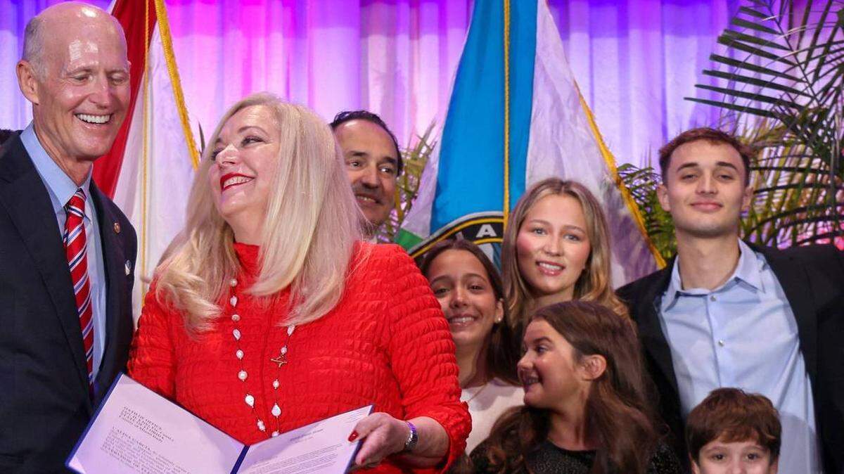 El senador Rick Scott (izquierda) sonríe con Alina García (centro) tras su juramento como supervisora ​​electoral de Miami-Dade en el Auditorio Milander de Hialeah, Florida, el lunes 13 de enero de 2025. Carl Juste cjuste@miamiherald.com