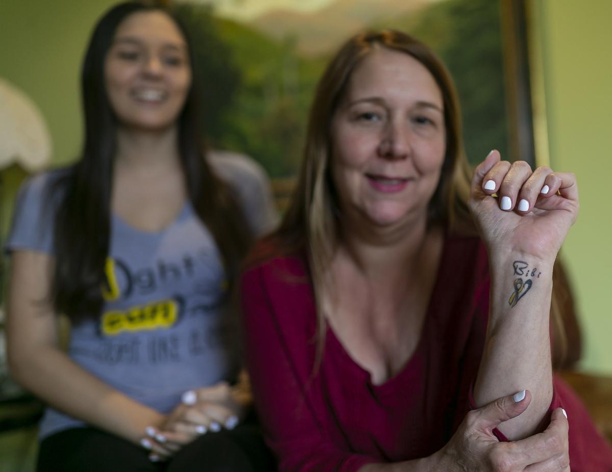 Grace Maderal shows a tattoo that she got in honor of her daughter, Bianca Maderal, 22, who was diagnosed with brain cancer. Bianca, a student at FIU who is graduating next week, has been battling with cancer for over four years. Through her journey she kickstarted a non-profit, Fight Like A Kid, where she aims to raise money to fund childhood cancer research, raise awareness of the disease and inspire those diagnosed with cancer. They were photographed at Bianca’s grandmother’s home in Kendall on Friday, December 13, 2019.