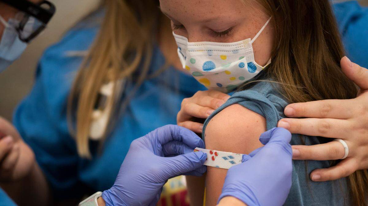 Marin Ackerman, 10, receives a bandage after getting a Pfizer-BioNTech COVID-19 vaccine in 2021, in Columbus, Ohio.