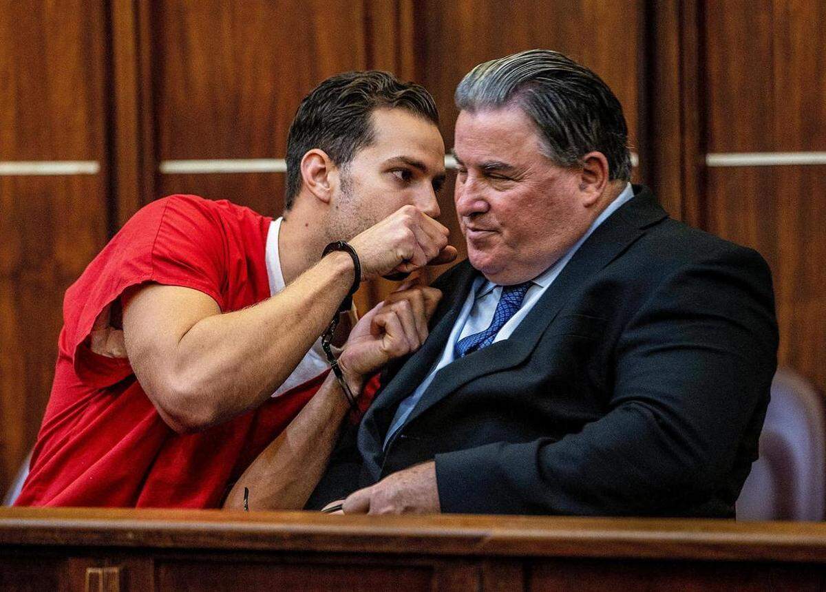 El ex policía de Hialeah, Rafael Otano, habla con su abogado defensor, Michael Pizzi.
