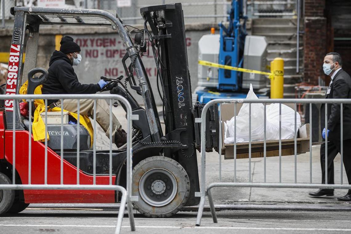 Bodies being loaded into a refrigerated truck outside the Brooklyn Medical Center in New York City on March 31, 2020.