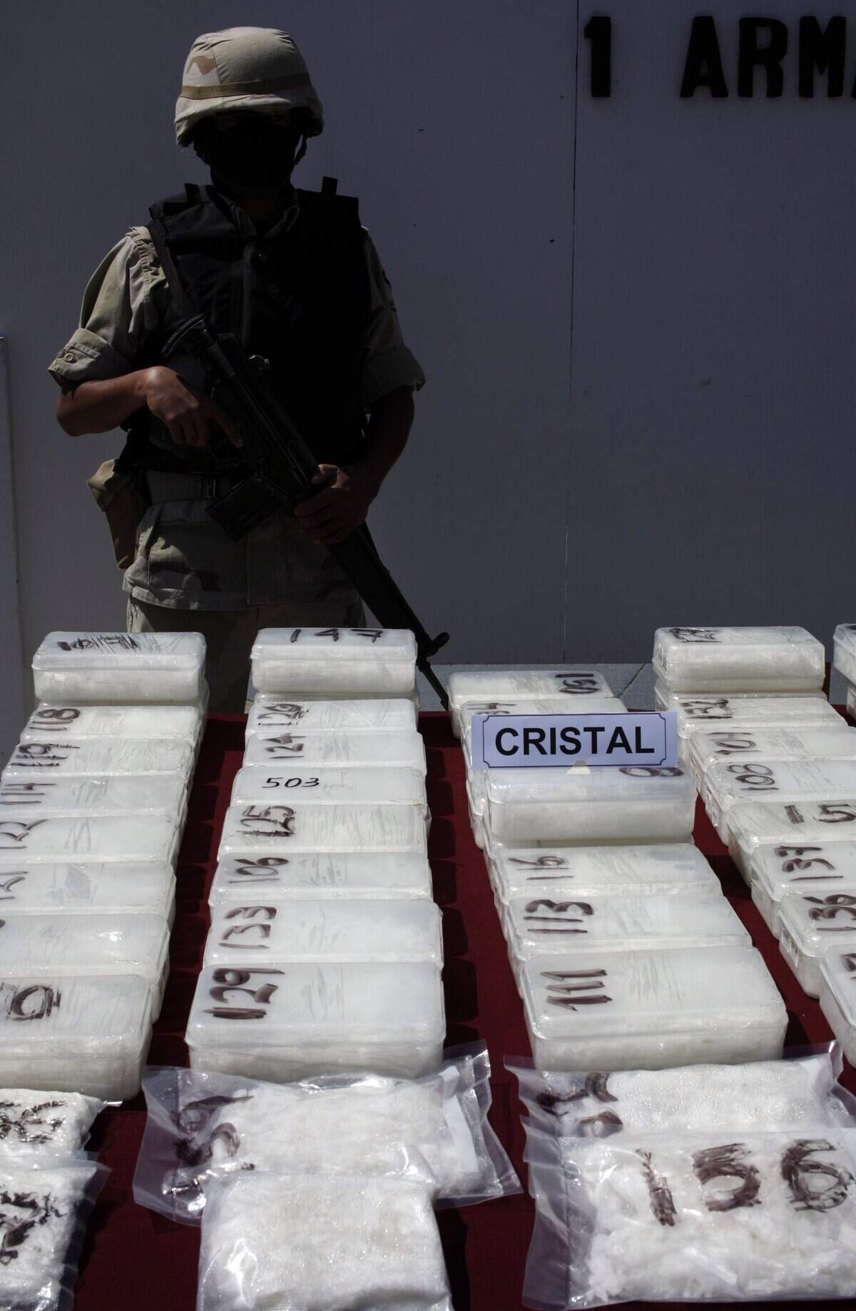 FILE - In this April 25, 2009, file photo, packages containing crystal methamphetamine seized during an anti-drug operation are displayed to the media in Tijuana, Mexico. Mexico’s most powerful drug cartel appears to be expanding methamphetamine production on a massive scale, filling a gap left by the breakdown of a rival gang that was once the top trafficker of the synthetic drug. The globe-spanning Sinaloa cartel is suspected of dealing record tons of drugs and precursor chemicals processed in industrial-sized operations. The apparent increase in the Sinaloa group’s involvement comes as the Mexican government says it has dismantled the La Familia gang with key arrests and killings of its leadership, and as Mexico is once again the primary source of meth to the United States, according to U.S. drug intelligence reports. (AP Photo/Guillermo Arias, File)