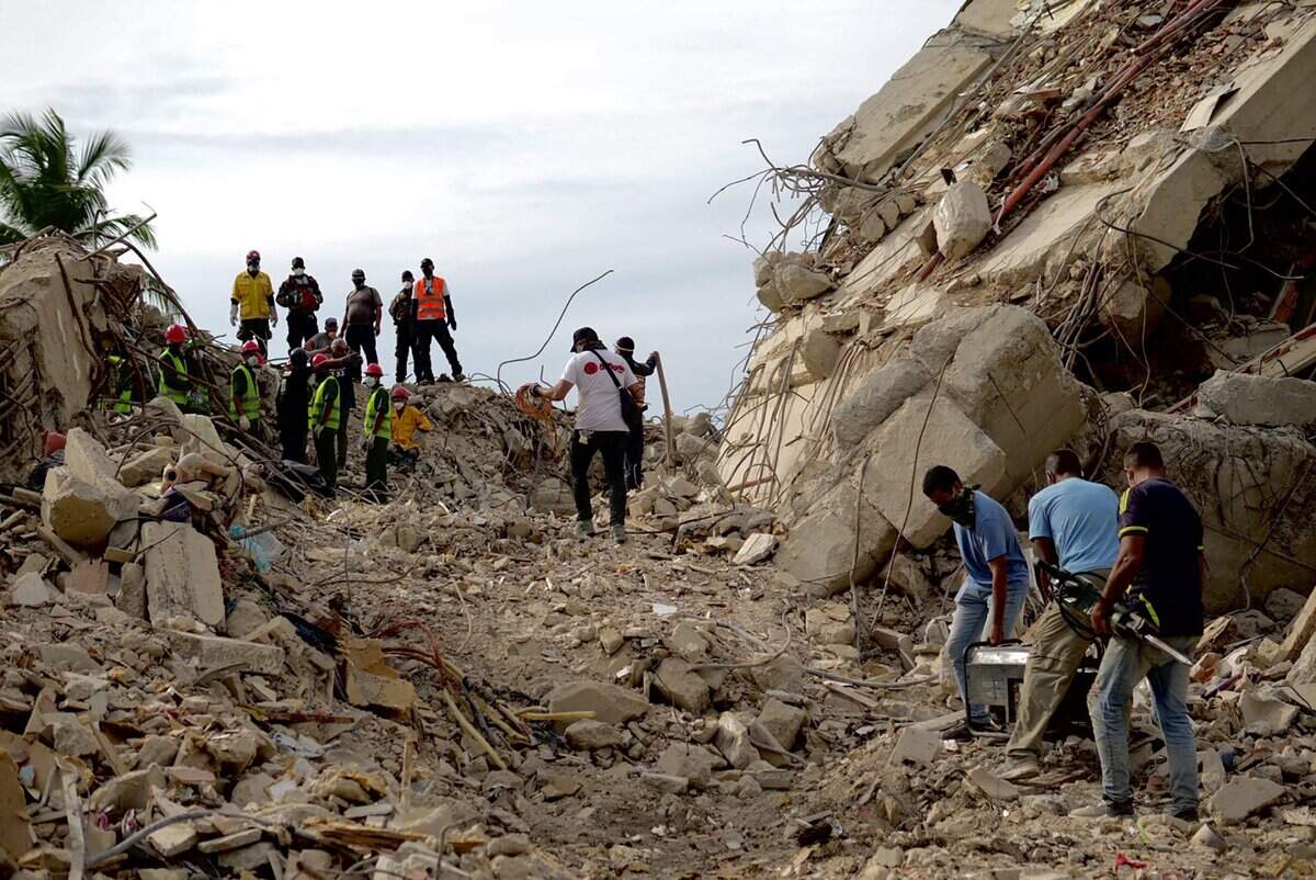 Rescuers search for vcitims of the June 24 twin quakes at the site of a collapsed building in Tanaguarena sector in Caraballeda, La Guaira State, Venezuela on July 3, 2026. The death toll from Venezuela's devastating twin earthquakes has risen to 2,645, with more than 12,600 injured and thousands mores reported still missing, according to new official figures. (Photo by Rosali HERNANDEZ / AFP via Getty Images)
