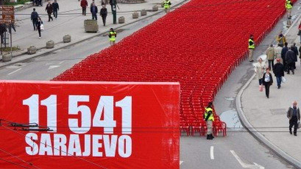 A view of chairs lined up along the main street in Sarajevo on April 6, 2012, to mark the 20th anniversary of the bloodiest conflict in Europe since World War II. More than 11,000 red chairs, symbolizing 11541 victims of the conflict, lined Sarajevo's main avenue today as Bosnians marked the anniversary of the bloody conflict with songs and remembrance. Thousands of people gathered as a choir accompanied by a small classical orchestra performed an arrangement of 14 songs, most of them composed during the city's bloody siege. AFP PHOTO / ELVIS BARUKCIC (Photo credit should read ELVIS BARUKCIC/AFP via Getty Images)