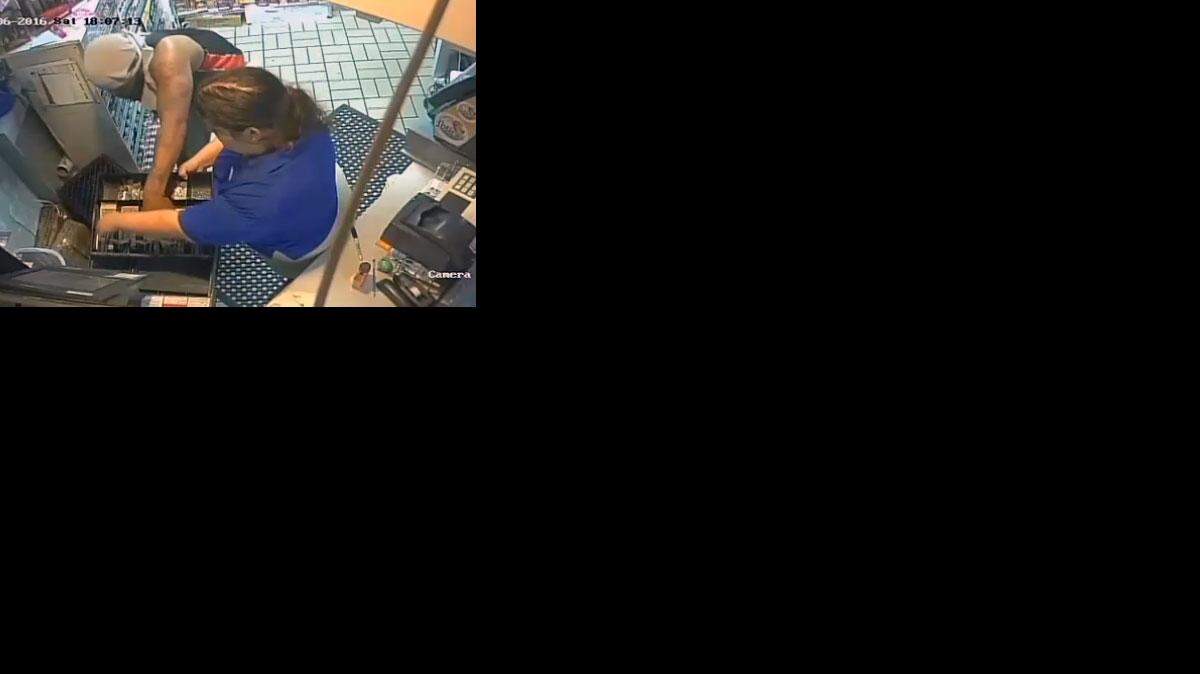 Después de perseguir a la mujer por la tienda, el hombre la obliga a colocarse detrás del mostrador.